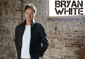 Bryan White in front of brick wall
